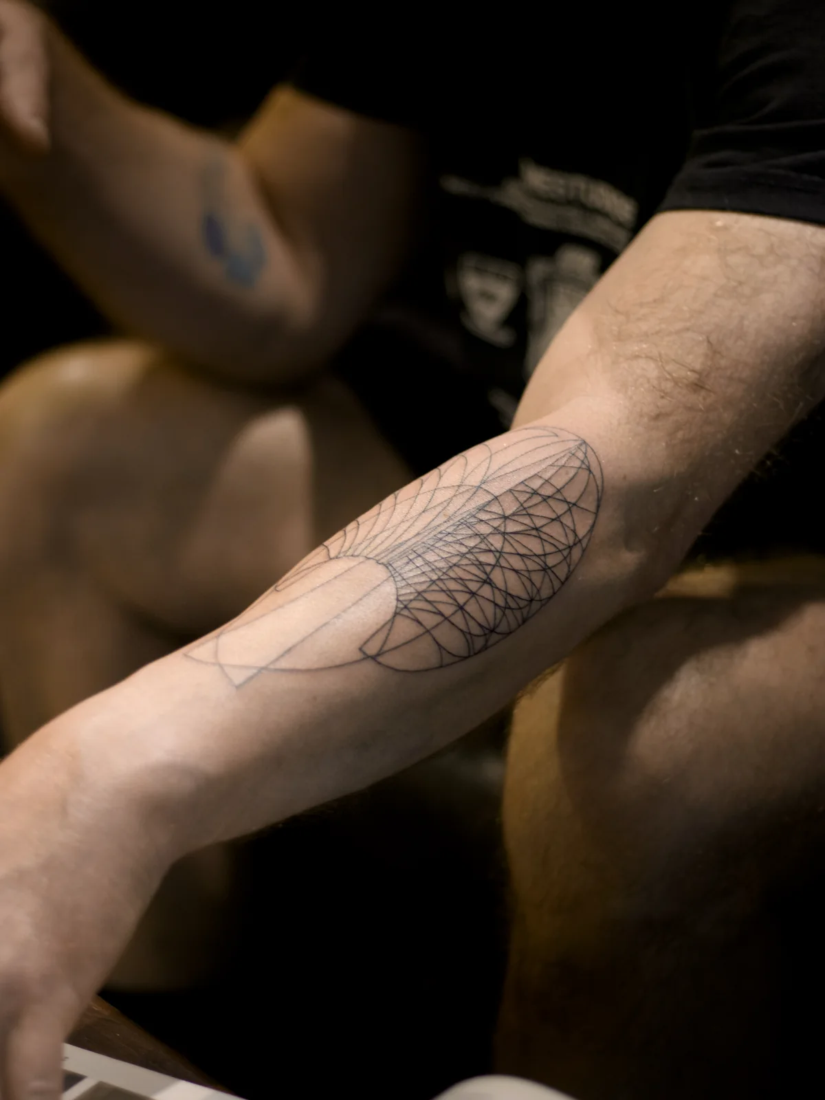 Full view of a fine line parametric geometry tattoo following the length and bend of the forearm, Prague by Andrey Kovalov